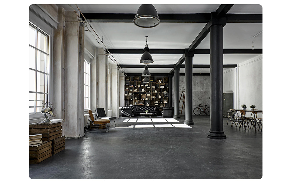 A wide angle view of the expansive interior of a converted warehouse residence